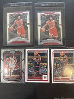 Six Coby White Chicago Bulls basketball trading cards in protective sleeves, showing front images of cards with different action shots and poses.
