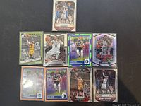 Nine Kyrie Irving basketball cards laid out on a black flat surface, showing multiple series and team representations including Cleveland Cavaliers and Dallas Mavericks.
