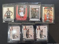 Photo showing all 7 LaMarcus Aldridge basketball cards in protective sleeves, featuring different designs and teams worn by Aldridge.