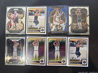 Eight Michael Porter Jr. basketball trading cards from NBA Hoops and Select series featuring Denver Nuggets imagery and various designs including holographic and refractor finishes, in mint condition, laid out flat in eight card sleeves.