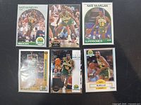 Photo showing all six Nate McMillan basketball cards arranged in two rows, featuring Seattle Supersonics branding and various poses of the player in green and yellow uniform.