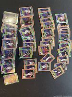 Piles and scattered layout of 53 NBA Hoops 2022-2023 Rising Stars basketball trading cards with varied color borders including purple, orange, and green. Player action images visible.