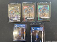 Five Patrick McCaw basketball cards from Panini and Donruss inside protective sleeves.