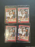 Four Paul Pierce basketball cards in protective sleeves, showing front design and condition.