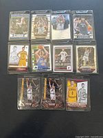 Photo of 11 Kevin Love basketball trading cards arranged in 4 rows, showing a mix of action poses and portrait style images in various team uniforms.