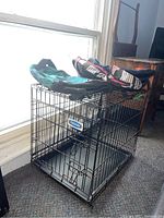 Photo shows metal wire pet crate with rust finish and one closed door.