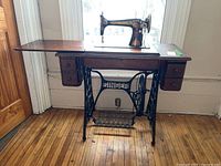 Full front view of machine in wooden table against window.