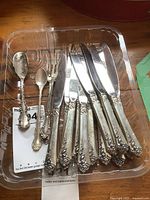 Tray of twelve butter knives, two small forks, sugar shell and baby spoon on plastic tray