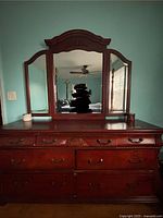 Front view of the dresser showing all mirrors attached and the carved wood details.