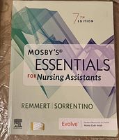 Front cover of the textbook showing the title 'Mosby’s Essentials for Nursing Assistants,' 7th edition, author names Remmert and Sorrentino, with a geometric pattern design in green and purple.
