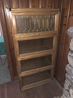 Front view of oak barrister bookcase showing all four shelves and doors