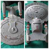 Two views of the USS Enterprise NCC-1701-D model showing top down details including ship hull, nacelles and registry markings.