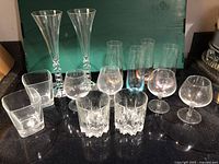 Photo showing all glassware including Prosecco flutes with unique 2000 shaped stems, old fashioned glasses, snifters, and highball glasses.