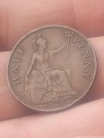 Reverse side of the coin showing Britannia seated with trident and shield, dated 1927 and inscribed HALF PENNY.