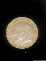 Obverse side of the 1927 copper coin showing dual profile portraits with inscriptions referring to Confederation and Canada.