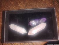 Set of three healing stone points on a black background: two Rose Quartz and one Amethyst, polished, double-terminated, about 1.35 inches each.