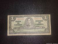 Front side of the Canadian one dollar banknote 1937 with serial number and King George VI portrait.