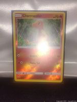Front face of the Charmander holographic Pokemon card displayed against a white background, showing holographic shine and full card details.