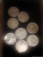 Top view of nine Canadian 5 cent silver coins showing obverse (heads) side with portraits and text.