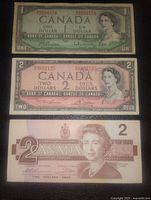 Front images of the 1-dollar and two 2-dollar Canadian banknotes showing portraits of Queen Elizabeth II and official Bank of Canada markings.