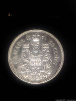 Obverse side of the 1971 Canadian 50 cents coin showing the coat of arms and date