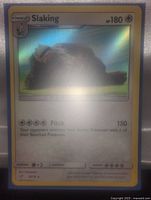 Shiny holographic Slaking Pokemon card showing front with attack and stats.