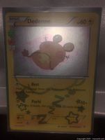 Photo of a holographic Pokemon card featuring a sleeping Dedenne with lightning-type energy and two attacks Rest and Pachi.