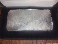 Front view of solid pewter ingot bar showing casting surface and rectangular shape