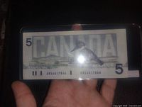 Back side of the 1986 Canadian 5 dollar bill showing a loon bird and the word CANADA, with the same serial number visible.