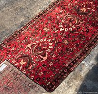 Full-length view of runner rug on concrete floor