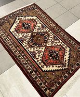 Angled full view of rug laid on tile floor showing overall pattern and dimensions