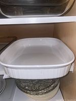 White ceramic square quiche pan with ribbed sides on white shelf