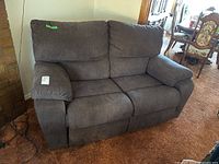 Front view of dark gray electric reclining loveseat showing overall condition and styling.