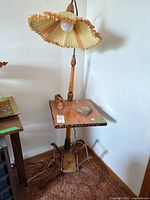 Full view of vintage floor lamp with wooden table and claw-style base, showing pen holders and glass ashtray on table surface