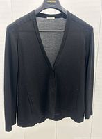 Front view of black cashmere cardigan showing V-neck, concealed button placket and pockets