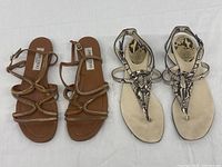 Both pairs of sandals side by side on white background