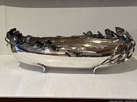 Side view of bowl showing hammered finish and sculptural floral rim