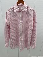 Pink and white striped Burberry dress shirt on hanger