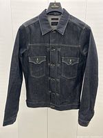 Front view of denim jacket on hanger
