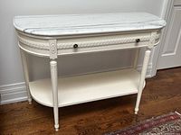 Front view showing marble top, carved apron, drawer front and lower shelf