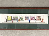 Straight-on shot of full framed diorama showing gallery wall, paintings, figures, and small sculpture.