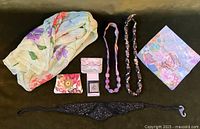 Photo 1 shows a floral sheer scarf, two coin wallets, two bead necklaces, a black elastic beaded headband, and a floral themed square scarf.