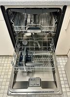 Interior with three pull-out racks and stainless steel tub visible