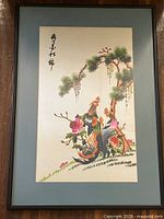 Front view of framed silk embroidered artwork featuring two pheasants, pine tree, and flowers, artist's signature visible.