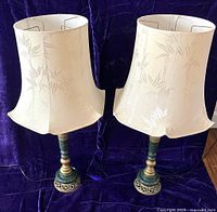 Pair of lamps with shades on a purple fabric background showing overall look and scale.
