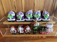Photo showing 5 felt handbag ornaments along with 3 red and white glass elf ornaments, 1 green glass elf ornament, and 1 fabric Christmas boot ornament.