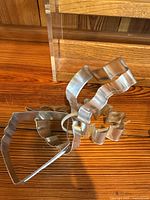 Top-down view showing stacked metal cookie cutters in assorted shapes including heart and star shapes.