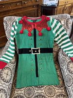 Green and red Christmas sweater with horizontal green-and-white striped sleeves, gold bell accents, pom-poms, black belt design, and red sequin collar from 'United States Southern' brand size Small