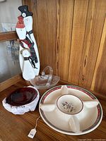 Photo showing the snowman figurine, Christmas divided plate, small bowl, and set of clear nested bowls.