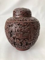 Front view of jar showing relief carving of landscape scene